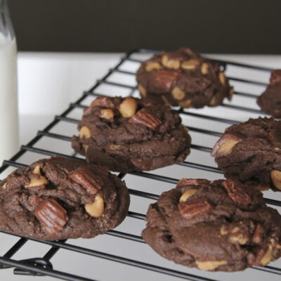 Chocolate peanut butter chip cookies on a wire rack.