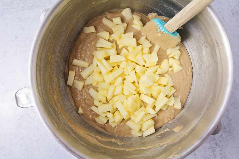 Ingredients for apple muffin recipe in a mixing bowl