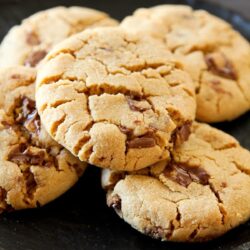 A plate with peanut butter cookies and Reese's cups.