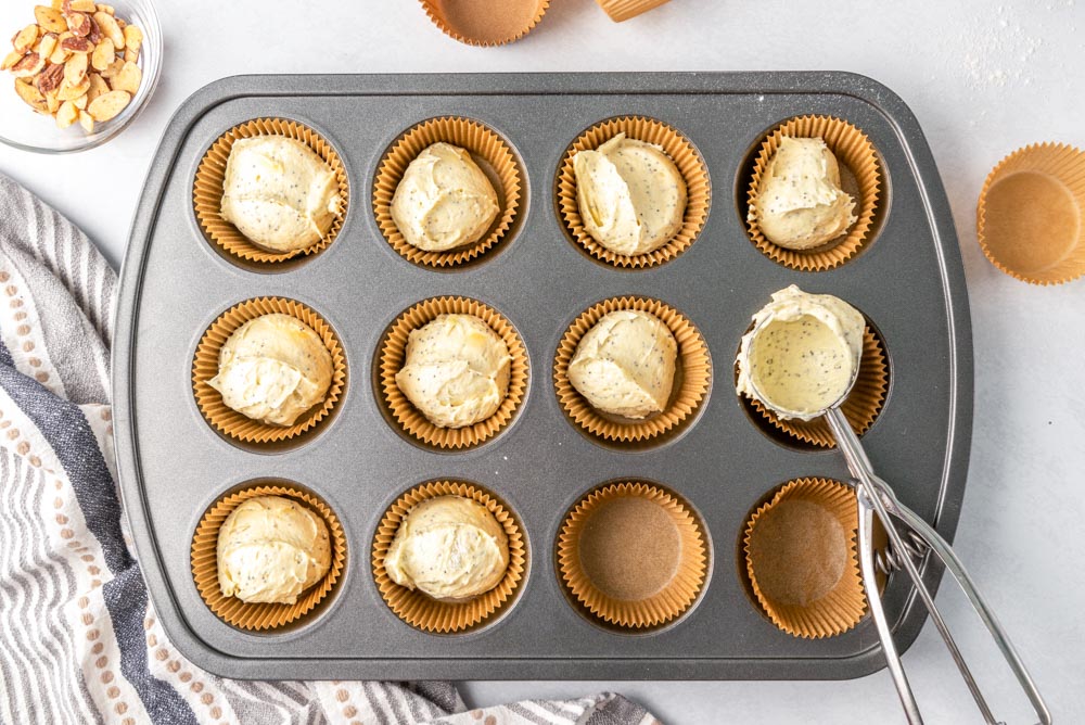 Scooping muffin batter into a muffin tip