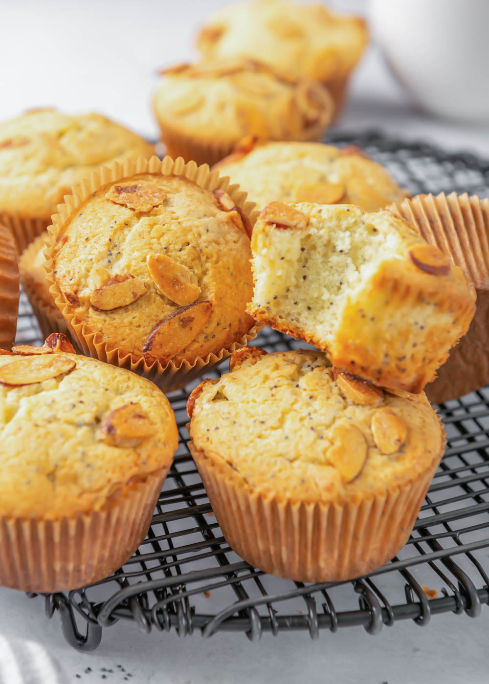 Close up of almond poppy seed muffins on a wire rack