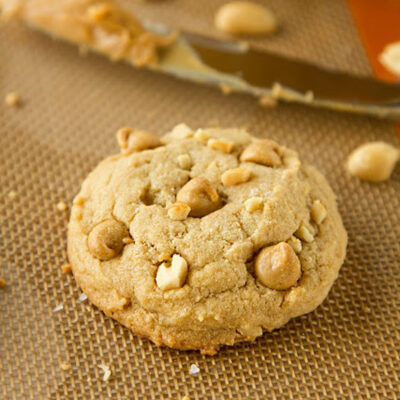 Crunchy peanut butter cookies on a silicone baking mat.