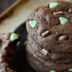 A stack of chocolate mint cookies with Andes on a plate.