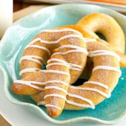 Cinnamon sugar soft pretzels on a blue dish.