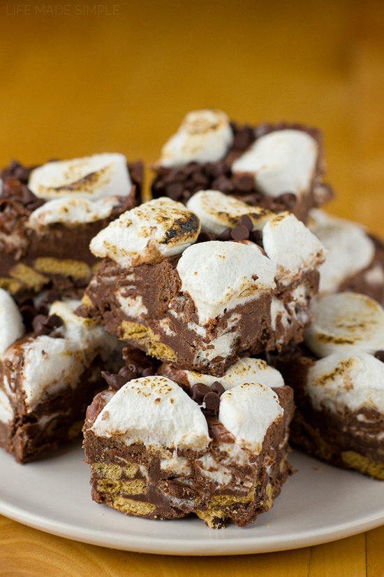 Fudgy S'mores Bars cut and stacked on a white plate
