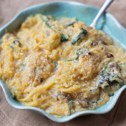 Baked spaghetti squash in a blue dish.
