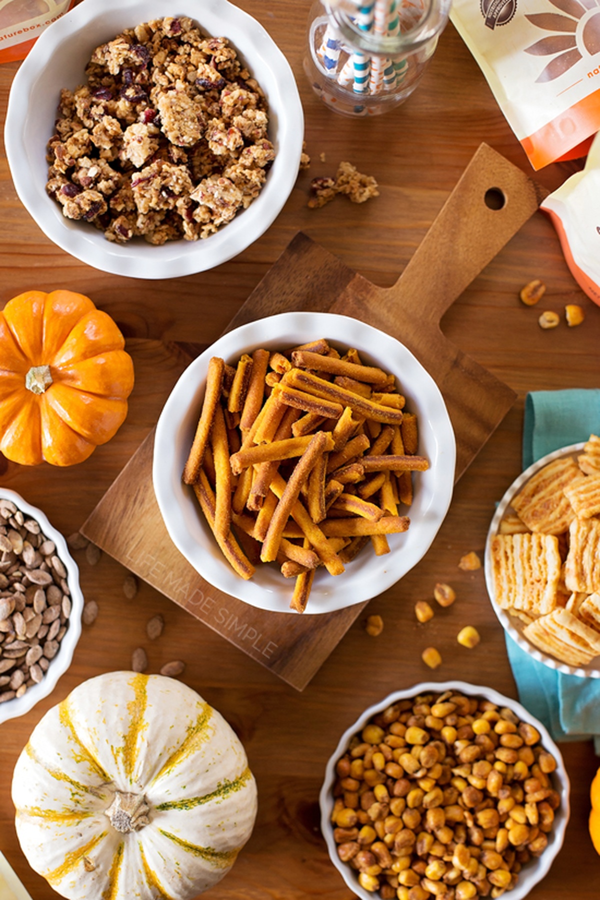 Two white bowls filled with autumn snack mix.