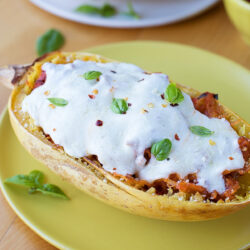 Sausage stuffed spaghetti squash on a plate.