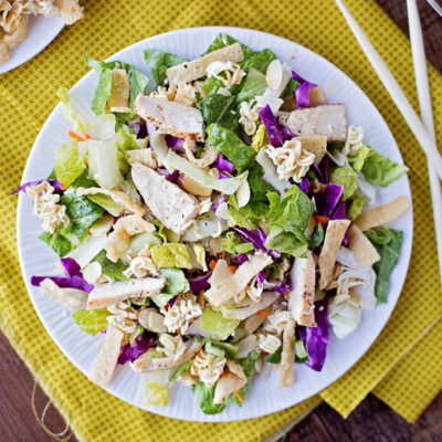 Asian ramen noodle salad on a plate, served with toppings.