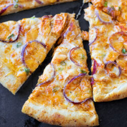 Slices of buffalo chicken pizza with spicy Cajun crust.