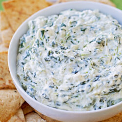 Greek yogurt artichoke dip in a white bowl.