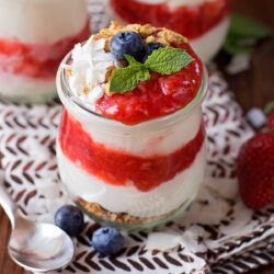 Berry yogurt parfait in a glass jar.