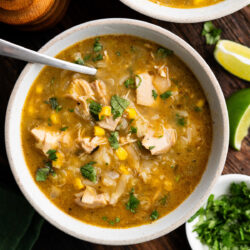 This bold and flavorful Green Chile Chicken Stew is ready to go in just 1 hour! It's loaded with shredded chicken, fresh corn, rice and of course, hatch chiles!