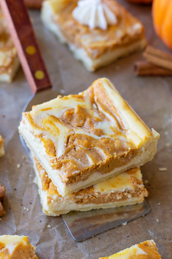 Pumpkin Pie Cheesecake Bars stacked and freshly baked