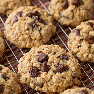Gluten-free oatmeal chocolate chip cookies on a cooling rack.