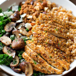 A plated serving of baked chicken couscous.