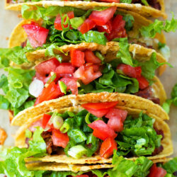 Turkey tacos arranged in a neat row.