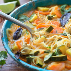 A bowl of curried chicken noodle soup.
