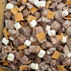 S'mores muddy buddies spread in a shallow pan.
