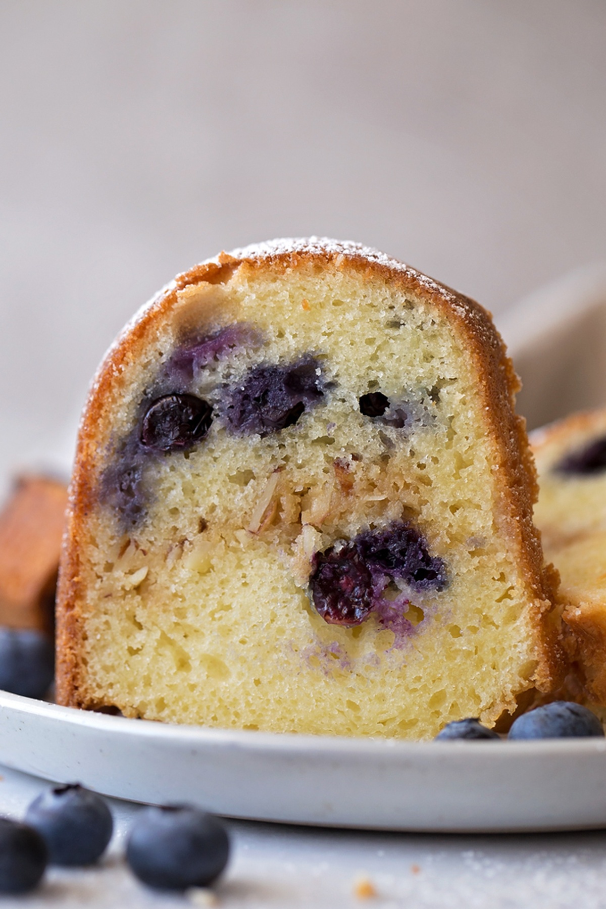 A baked Blueberry Almond Bundt Cake dusted with powdered sugar.