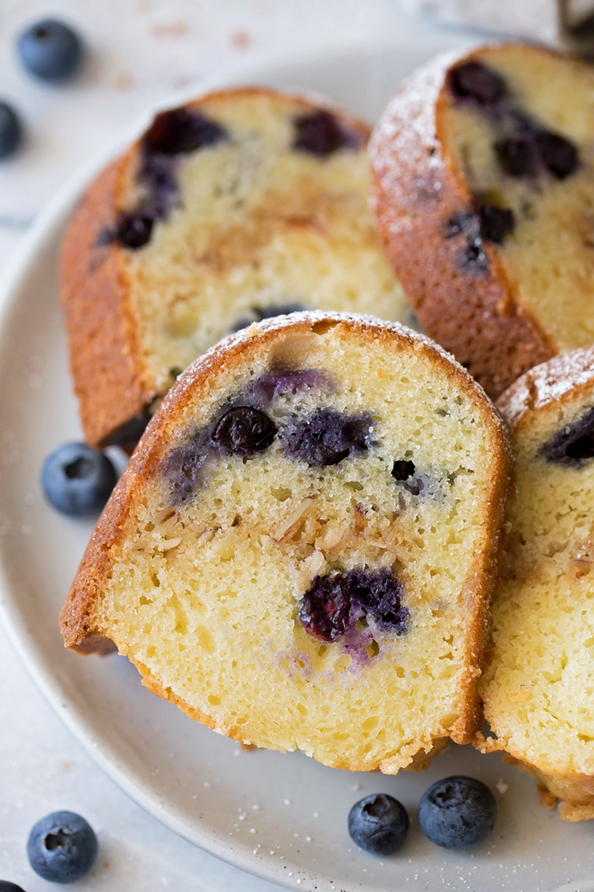 Close-up of a slice of Blueberry Almond Bundt Cake.