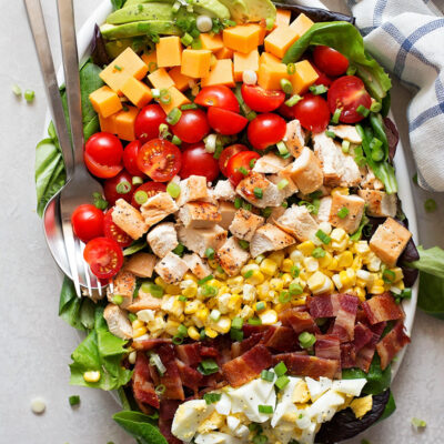 Cobb salad with corn on a serving platter.