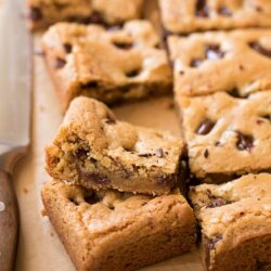 Close-up of chocolate chunk cookie bars with golden edges and gooey centers.