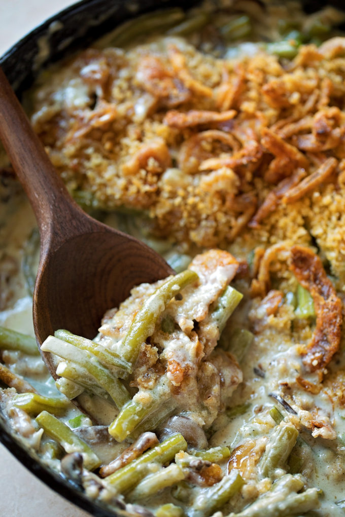 A spoon full of homemade creamy green bean casserole.
