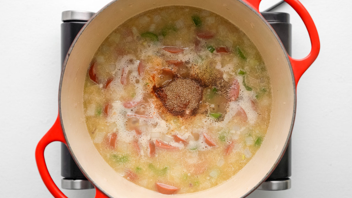 Broth and spices added into the Dutch oven.