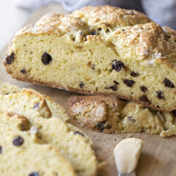 Irish soda bread with raisins on a wooden board.