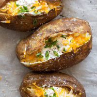 Easy Instant Pot baked potatoes fully loaded and ready to devour in just 40 minutes.
