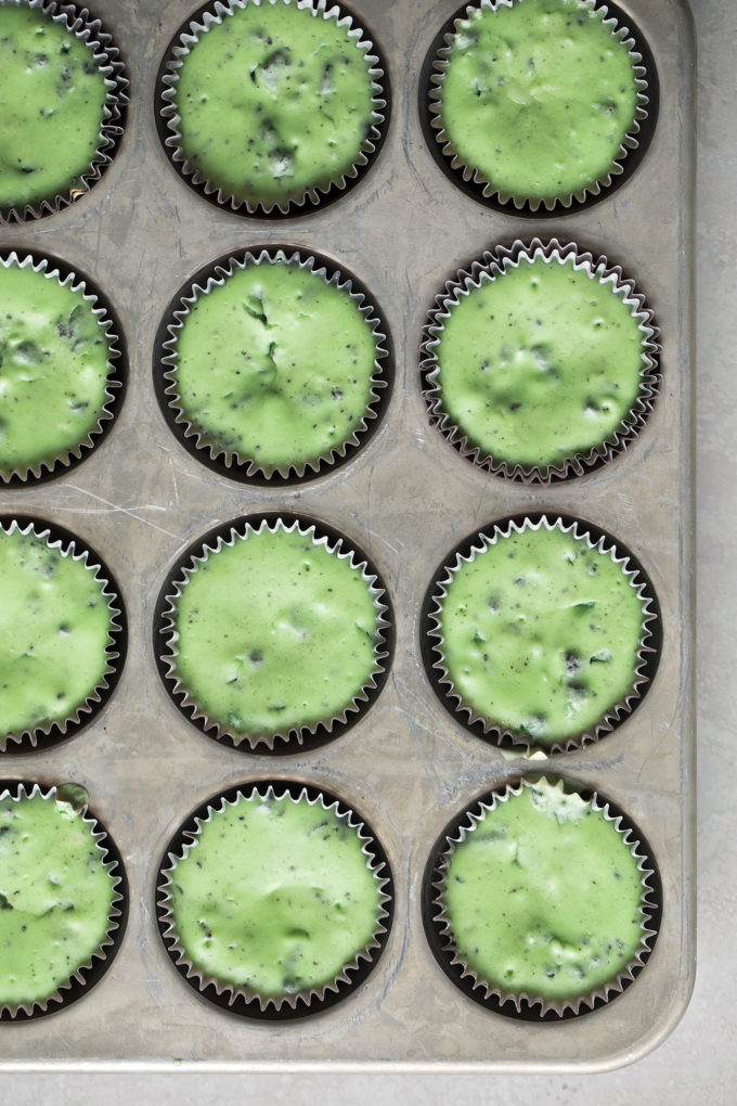 Mini mint oreo cheesecakes baked in a muffin tin.