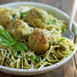Chicken meatballs with pesto served on a plate.