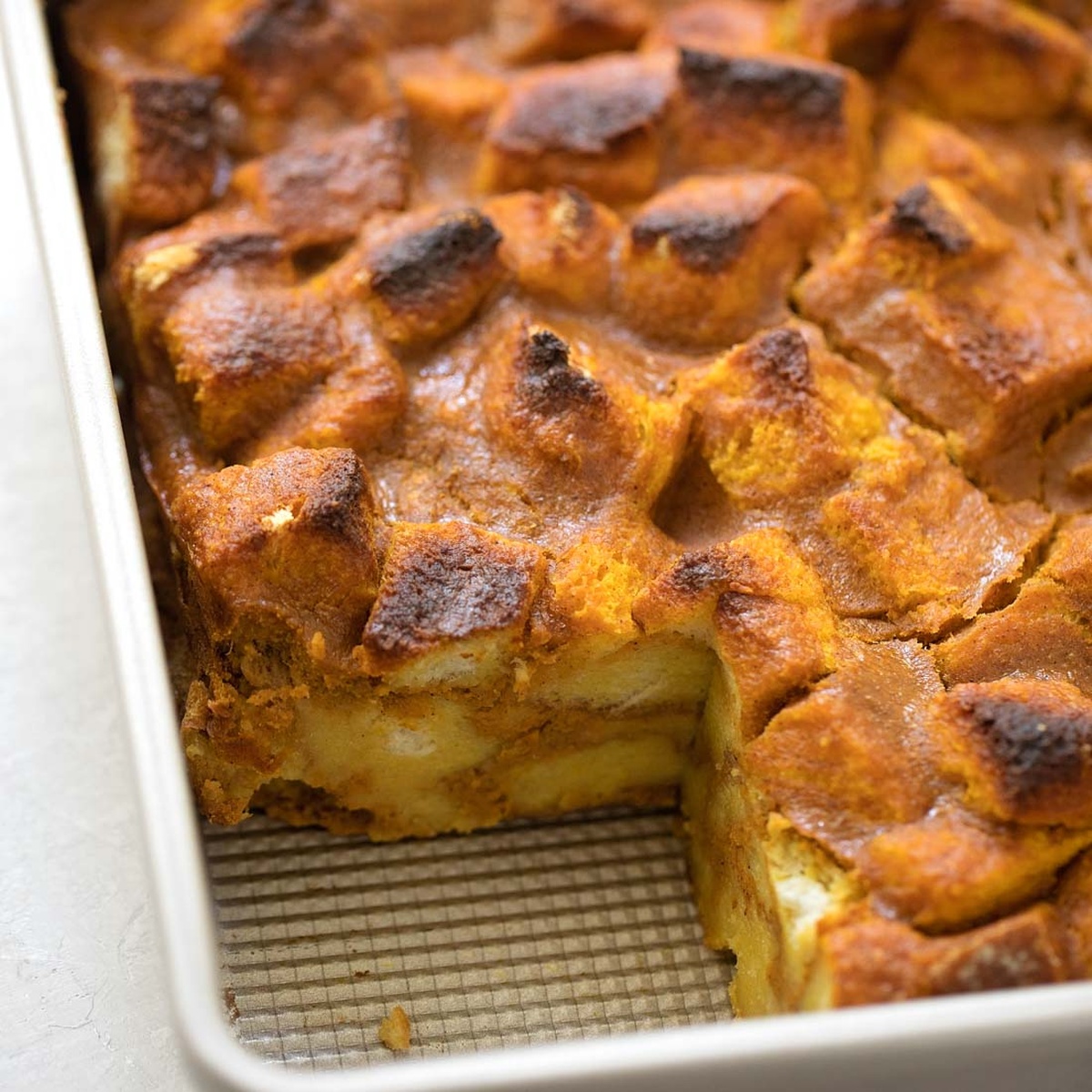 A baking dish with freshly baked pumpkin bread pudding.