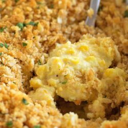 Cream corn casserole topped with golden breadcrumbs.