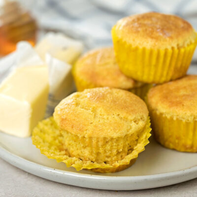 A plate with honey cornbread muffins.