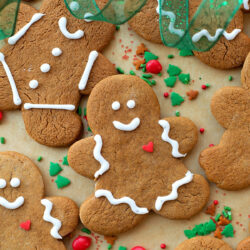 Classic gingerbread cookies arranged on parchment paper.
