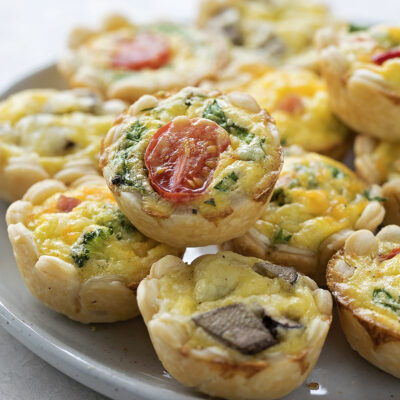 A plate of assorted mini quiches.