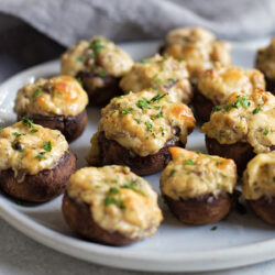 A plate of sausage stuffed mushrooms.