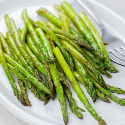 Close-up of roasted asparagus on a plate.