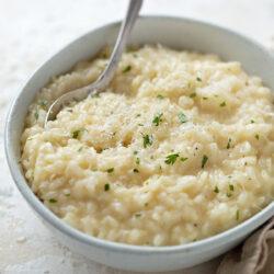 Instant Pot risotto in a white bowl.