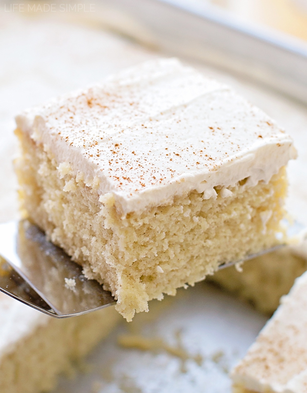You're going to fall in love this tres leches cake - I did! It's tender, moist and sweet, the perfect treat for your Cinco de Mayo fiesta!! A slice of Tres Leches Cake with whipped cream topping, dusted with cinnamon.