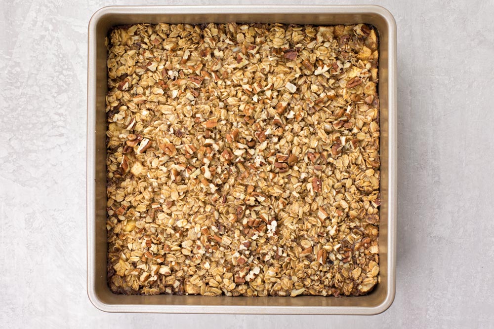 This Healthy Baked Apple Oatmeal is hearty and it's delicious! So easy to make, and perfect for a quick, healthy breakfast or snack throughout the week! Healthy baked oatmeal in a baking pan