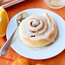 Homemade orange roll on a plate.