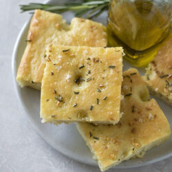 Easy focaccia served with a bottle of olive oil.
