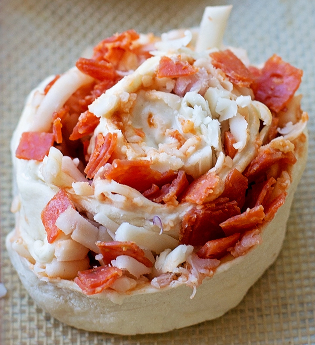 Close-up of a single pepperoni pizza pinwheel.
