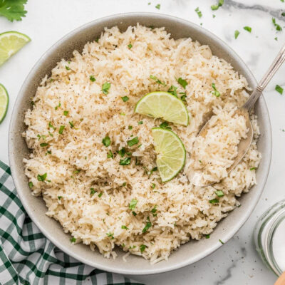 A serving bowl filled with lime coconut rice.