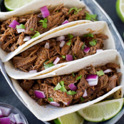 Three soft-shell tacos filled with shredded Beef Barbacoa.