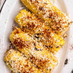 Mexican corn on the cob on a serving platter.