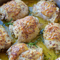 Honey mustard chicken in a skillet.